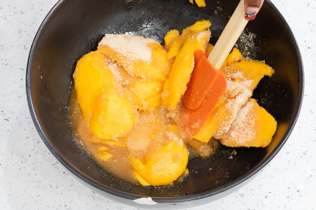 mango mix with sugar in black bowl