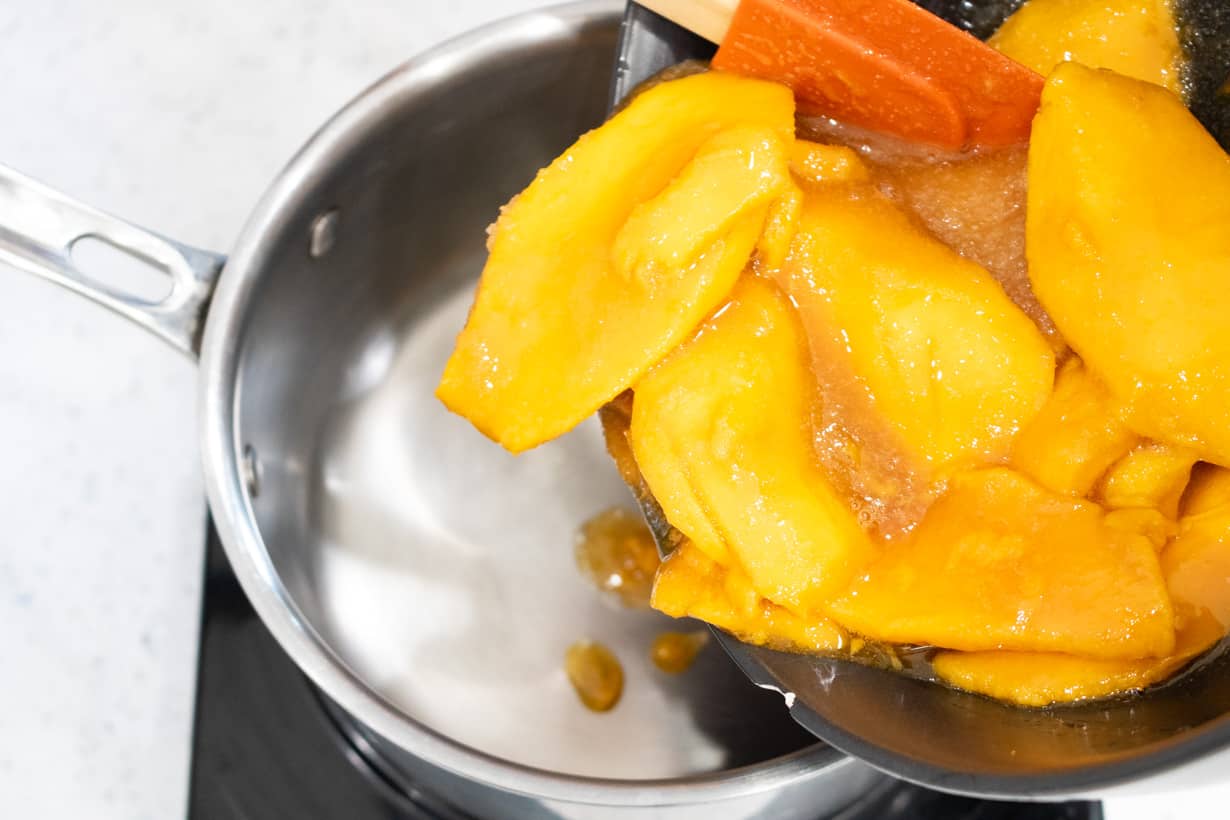 pouring mango mixture in saucepan