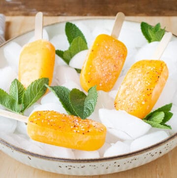 Mango popsicles on ice with mint