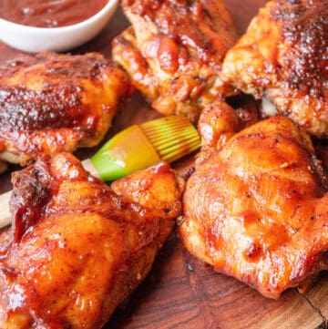 smoked bbq chicken thigh on wooden board