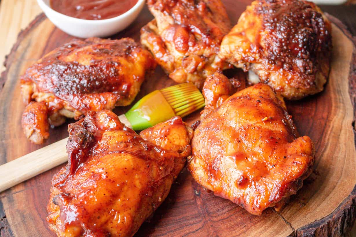 smoked bbq chicken thigh on wooden board