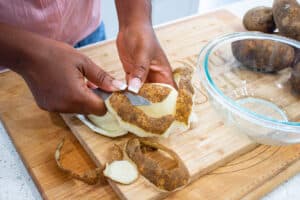 Hands peeling potatoes