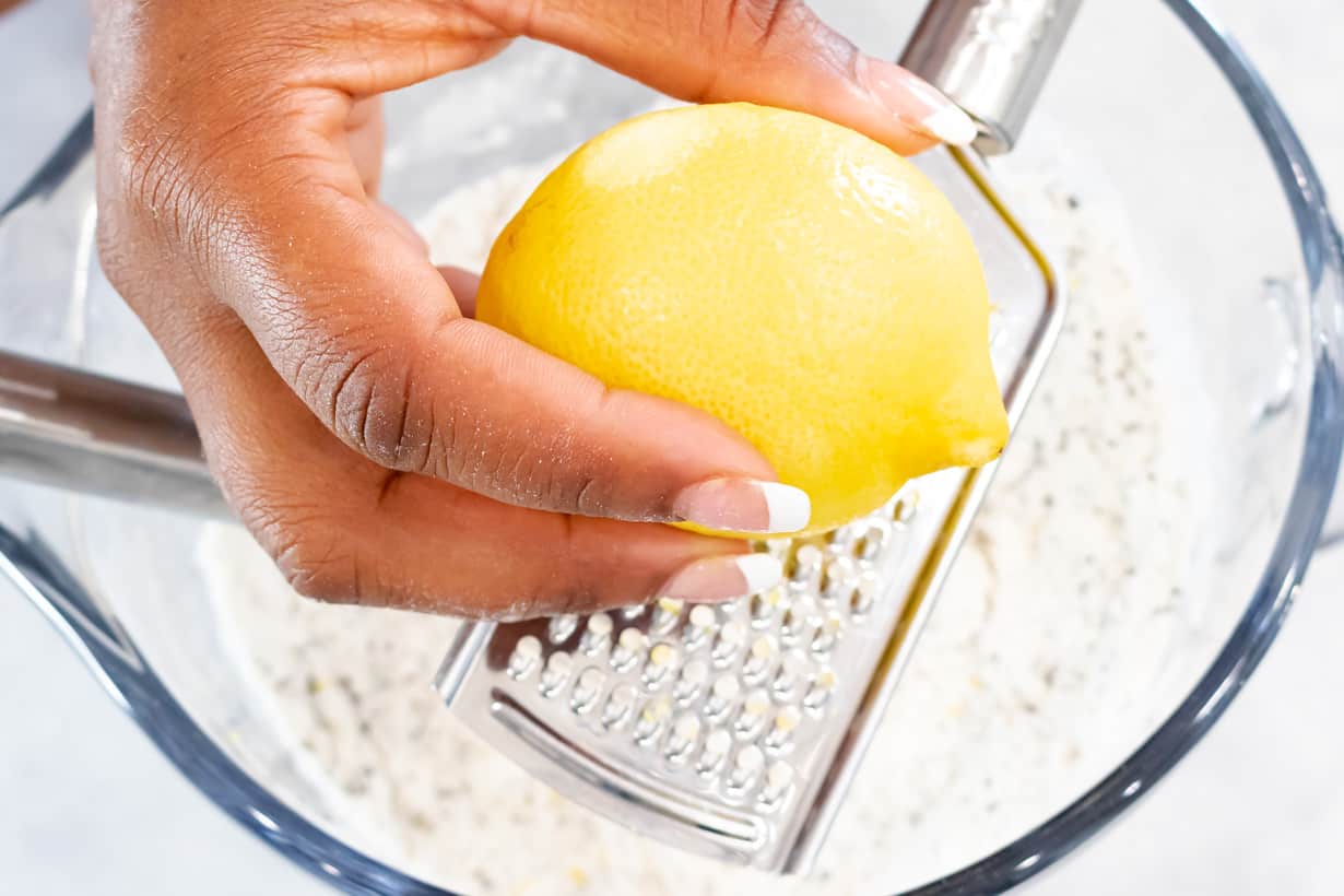 grating lemon in bowl