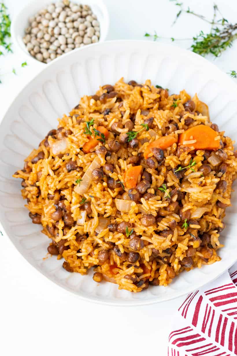 rice and pigeon peas in white bowl with peas