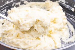 Spoon stirring mashed potatoes