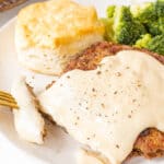gravy over chicken steak on a plate