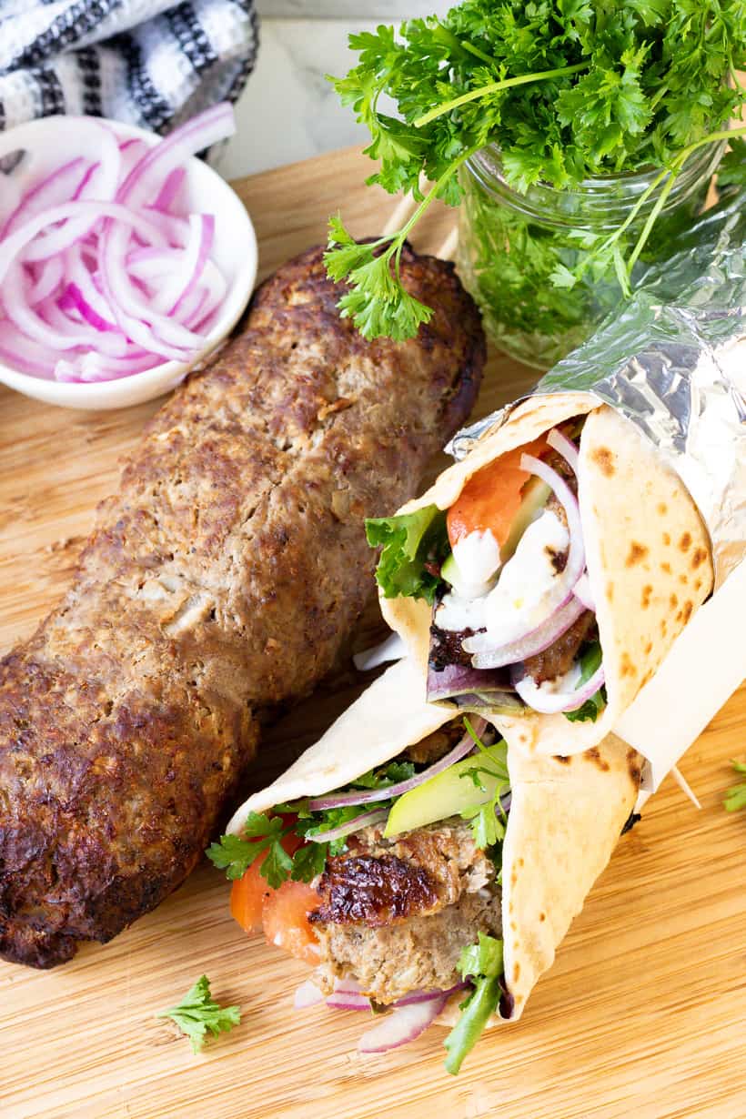 doner kebab and wraps on wooden board