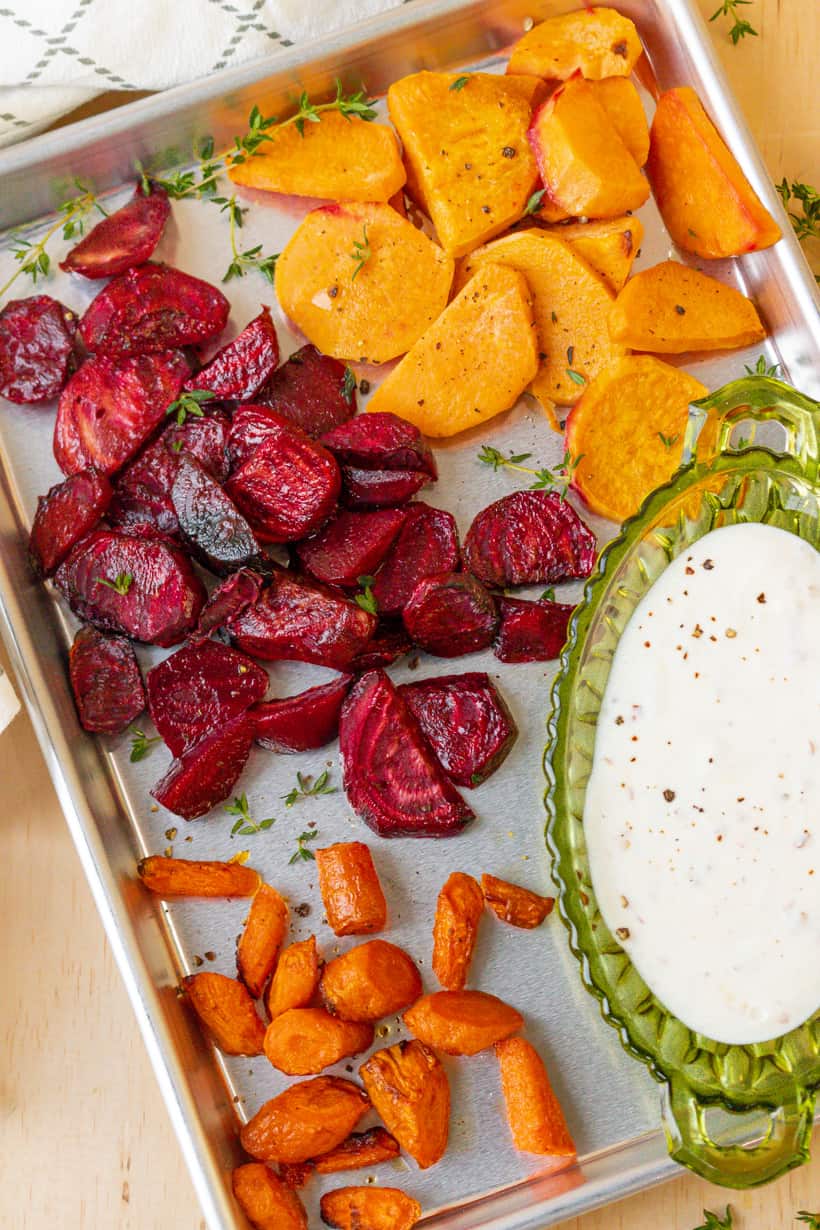 air fryer roasted vegetables in baking tray with yogurt sauce