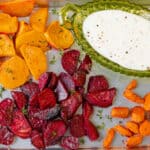 air fryer roasted vegetables in baking tray with yogurt sauce