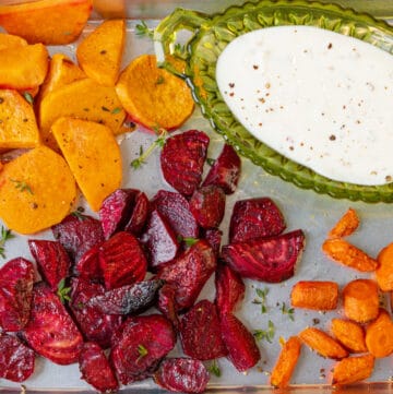 air fryer roasted vegetables in baking tray with yogurt sauce