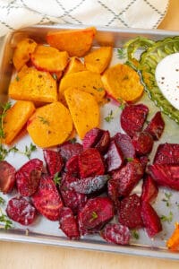 air fryer roasted vegetables in baking tray with yogurt sauce
