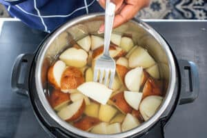 fork piercing through potatoes