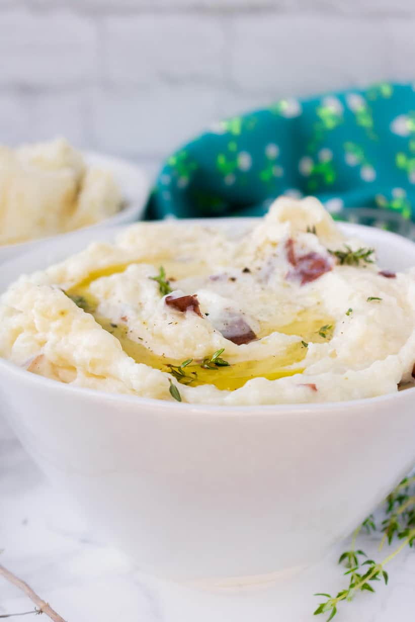 mashed potatoes with herbs and butter in white bowl