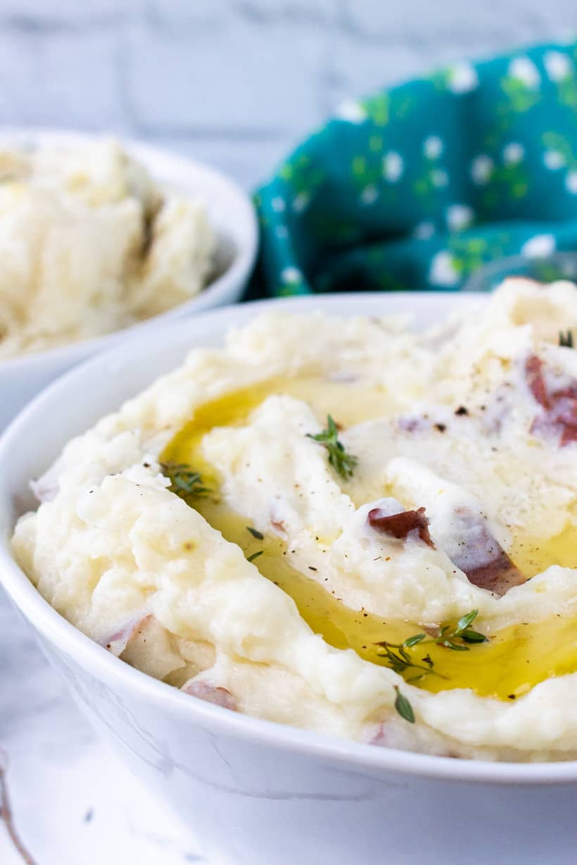 mashed potatoes with herbs and butter in white bowl