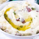 fluffy red mashed potatoes in white bowl