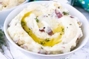 fluffy red mashed potatoes in white bowl