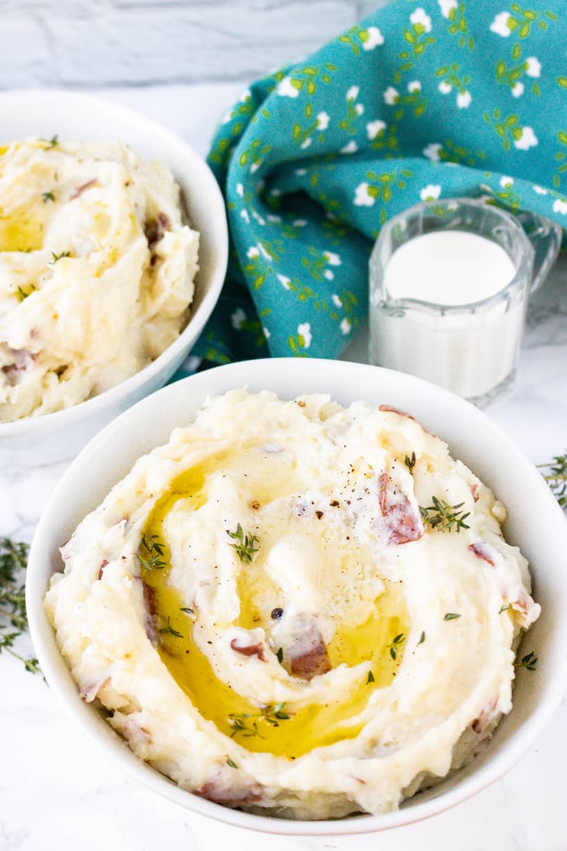 mashed potatoes in white bowl with creamer