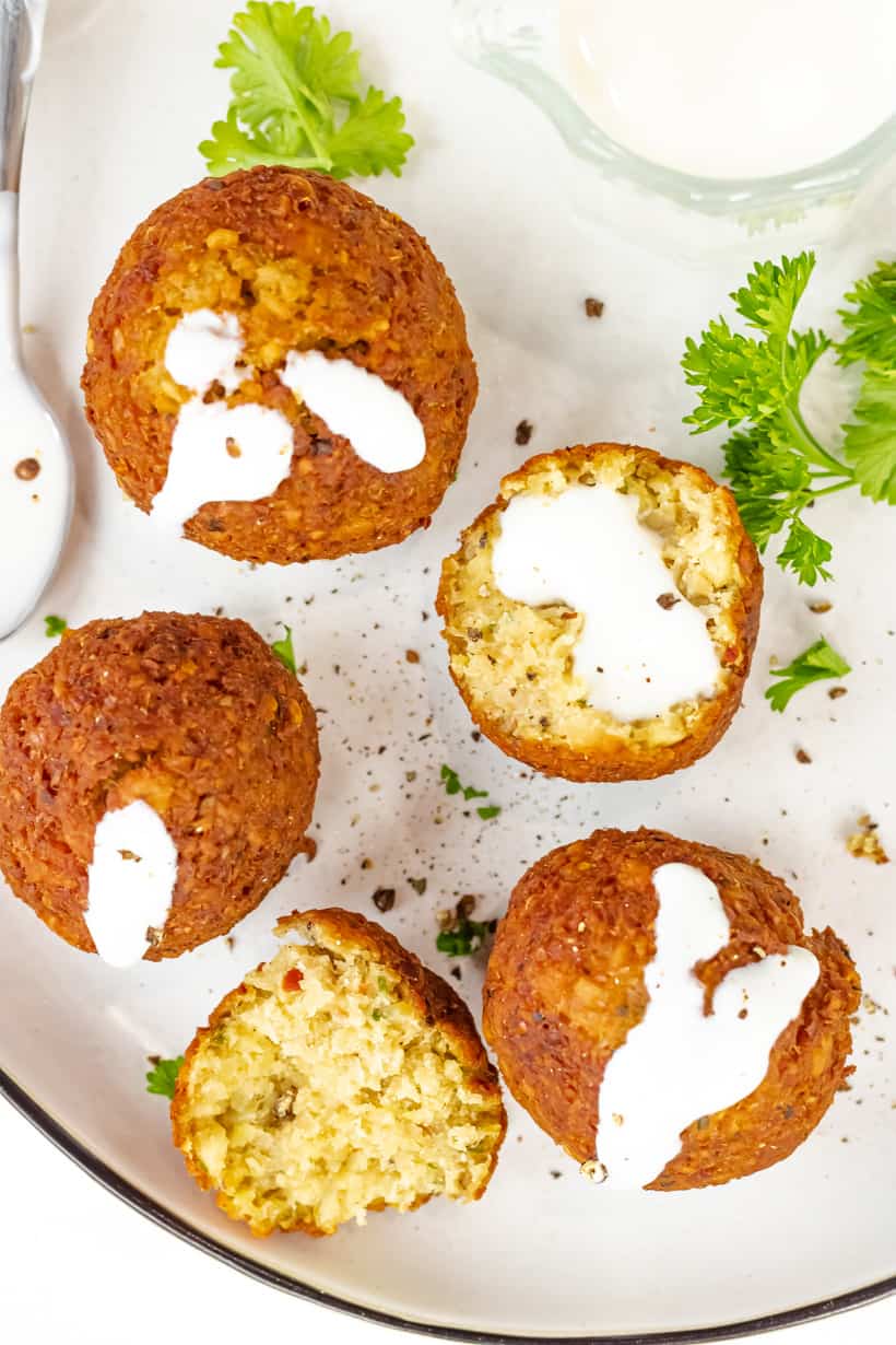 falafel balls with yogurt on white plate