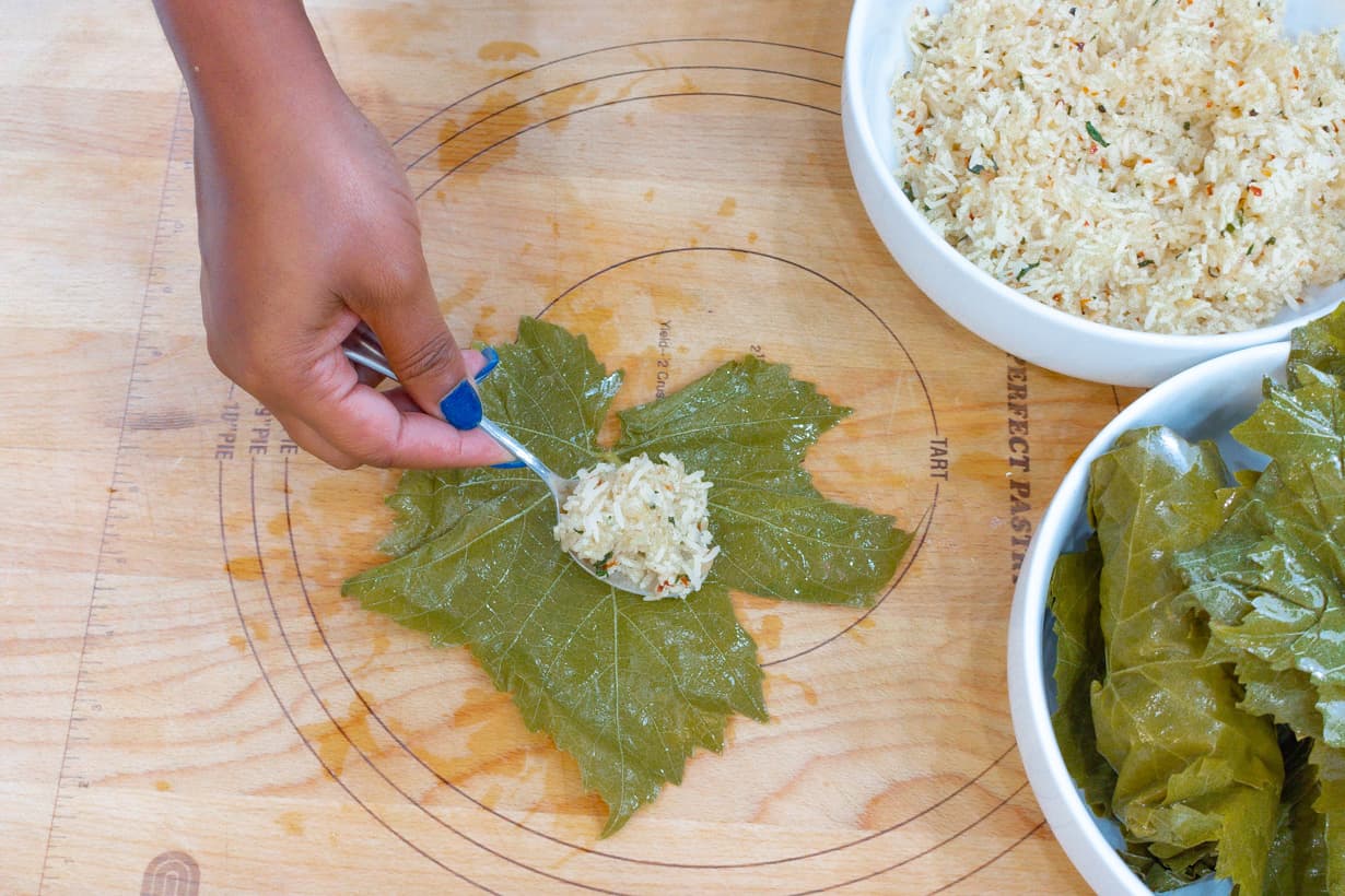 adding filling to leave on wooden board