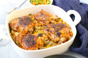 cooked chicken and rice in white baking dish