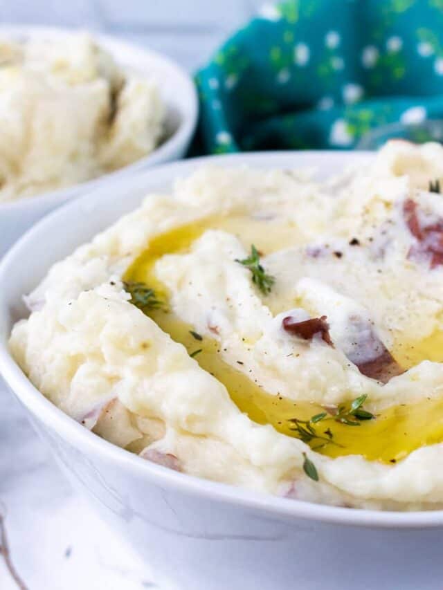 mashed potatoes with herbs and butter in white bowl