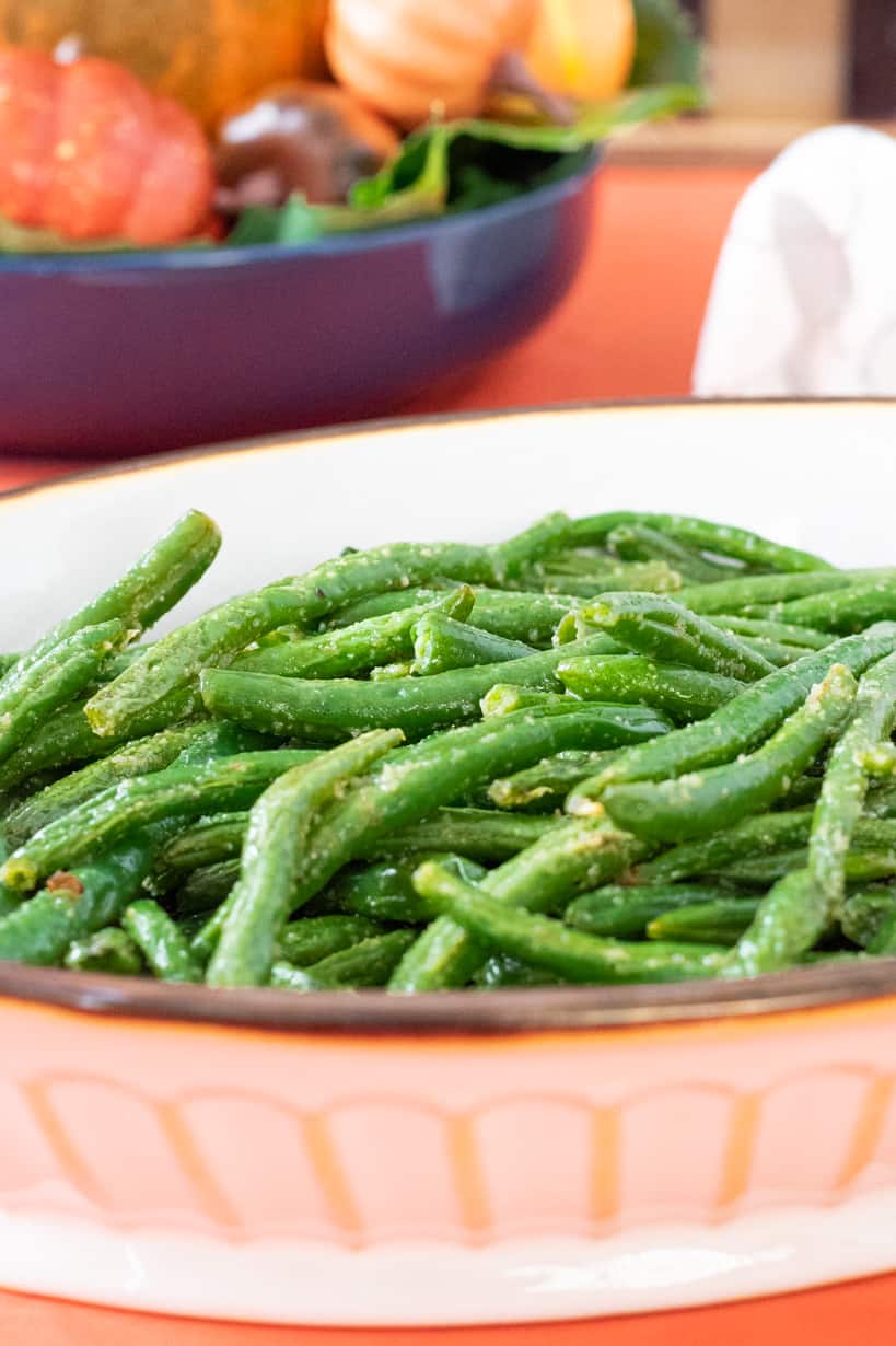 cooked green beans in a white bowl