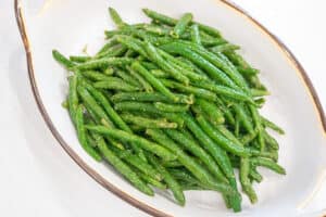 cooked green beans in a white bowl