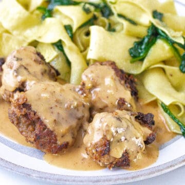Swedish Meatballs on with plate noodles and spinach