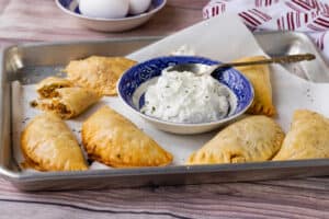 empanadas in tray with sauce