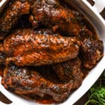 fully cooked turkey wings in white baking dish