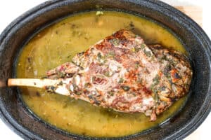 Cooked leg of lamb in roasting pan