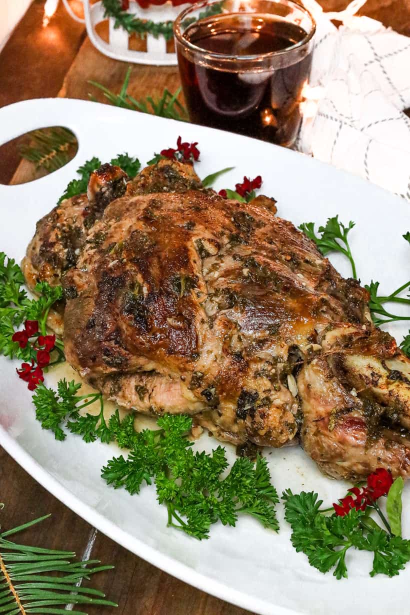 lamb on white plate with fresh parsley