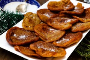 beignets dusted with sugar stacked up