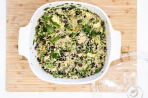 mixed salad with quinoa and avocado in white bowl