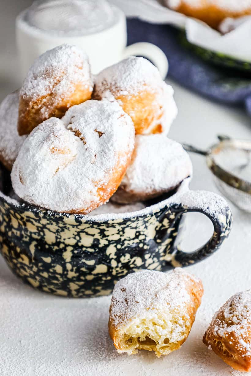 vegan beignets in large cup with dough