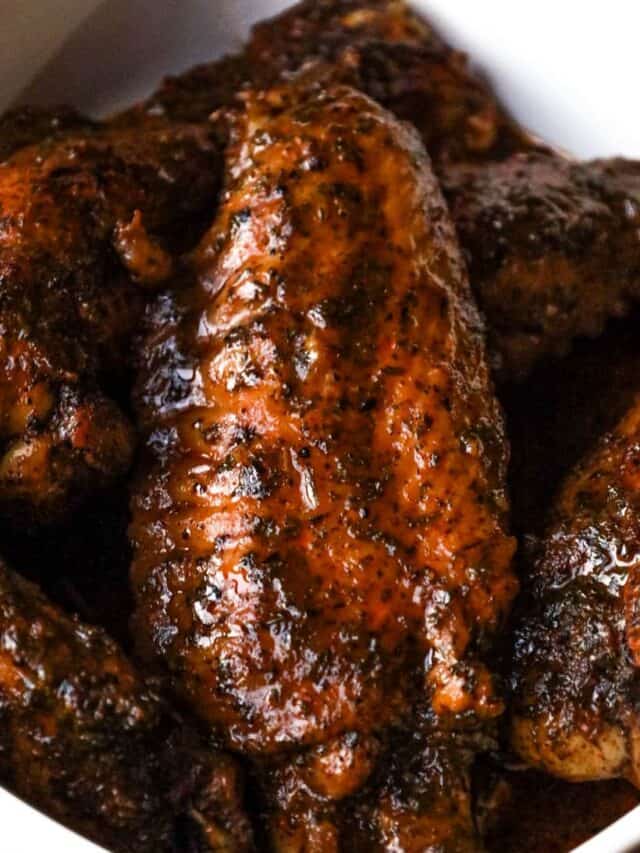 turkey wings stacked on each other in baking dish