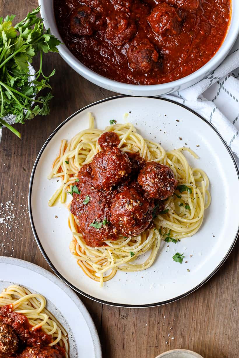 slow cooked meatballs over spaghetti