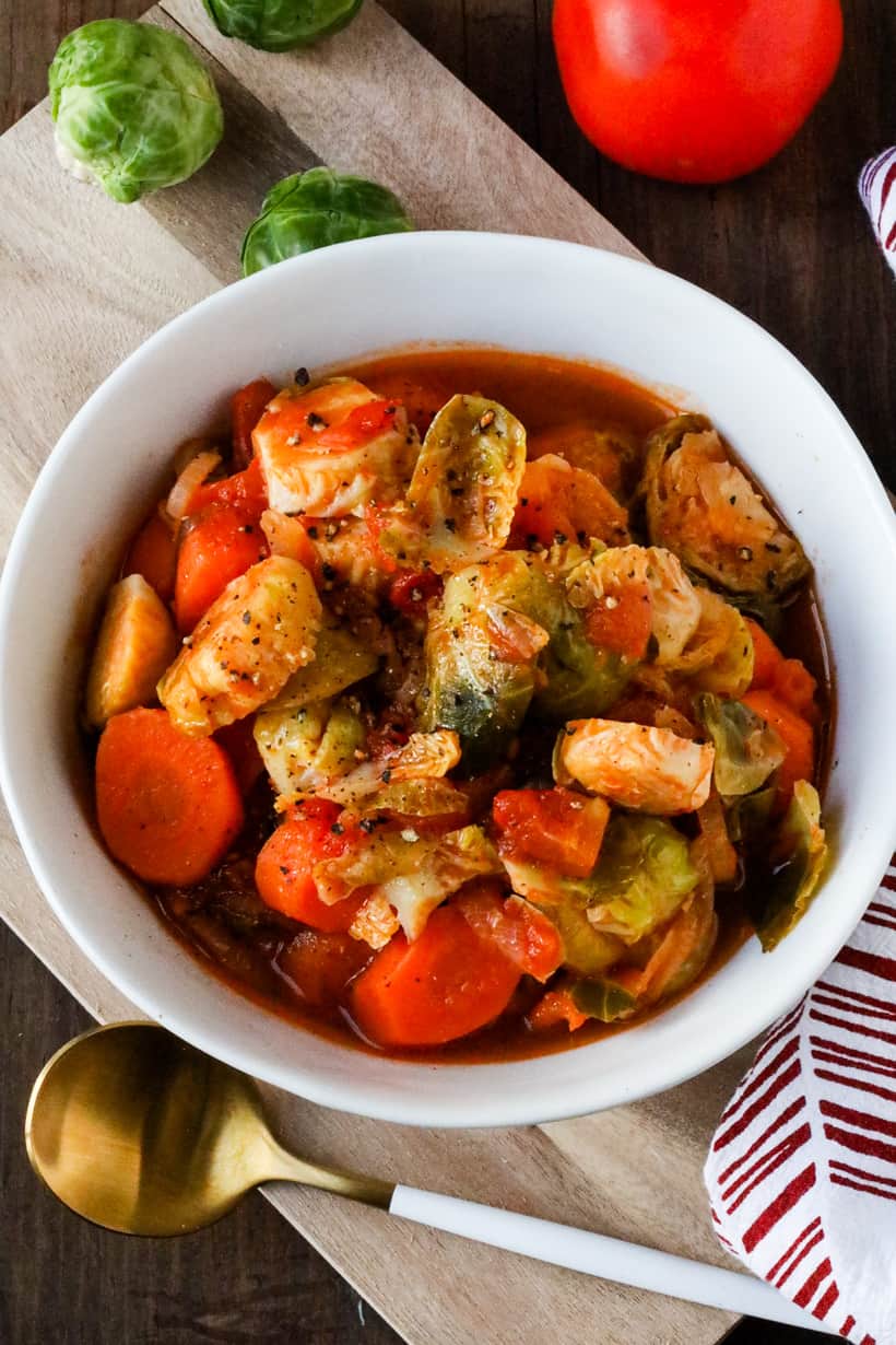 Brussels Sprouts And Carrots Stew on wooden board with spoon