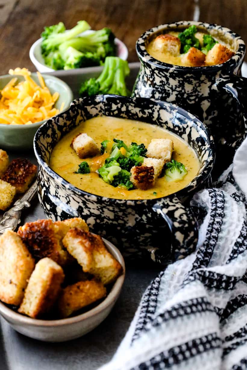 soup topped with bread, Broccoli and cheese on tray