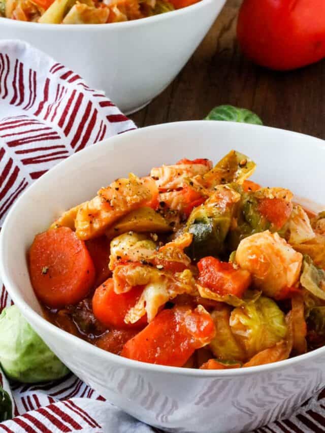 brussels sprouts stew with carrots in white bowl