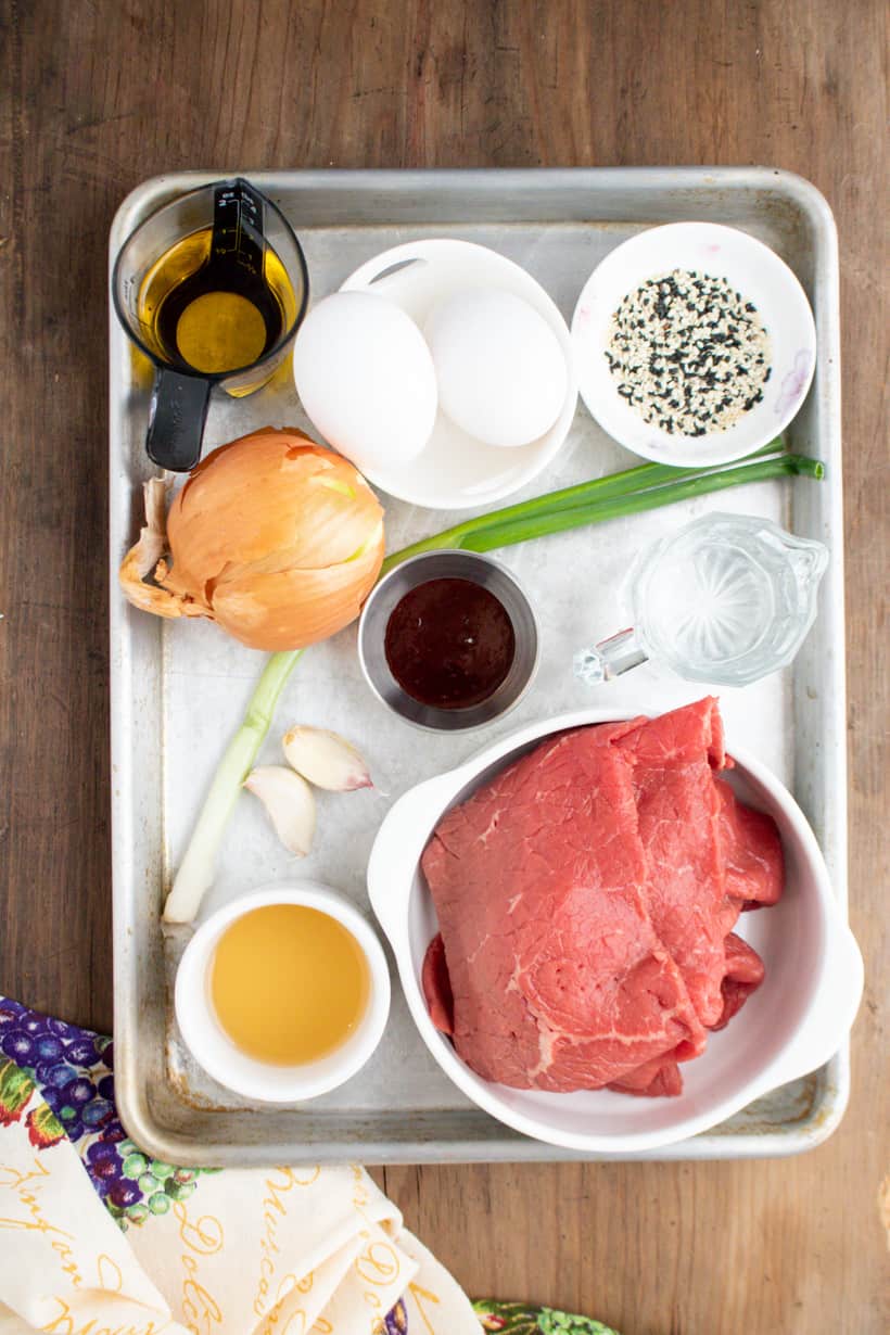 Ingredients to make beef ramen soup on tray