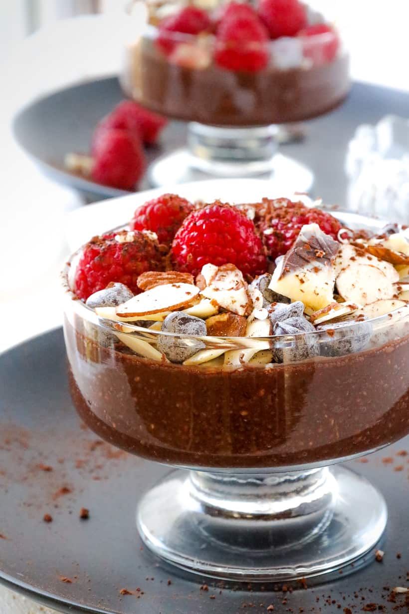 pudding topped with fruits on black plate