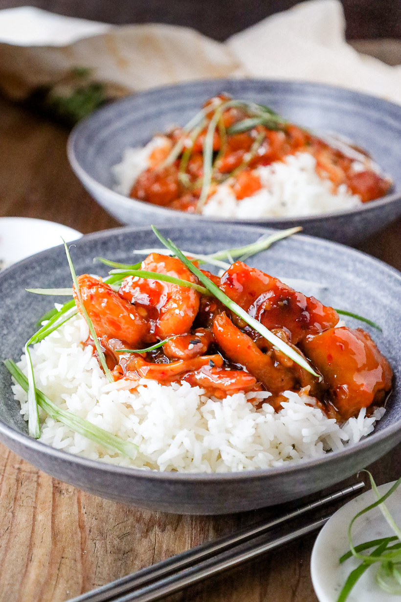 firecracker chicken on top of rice with green onions