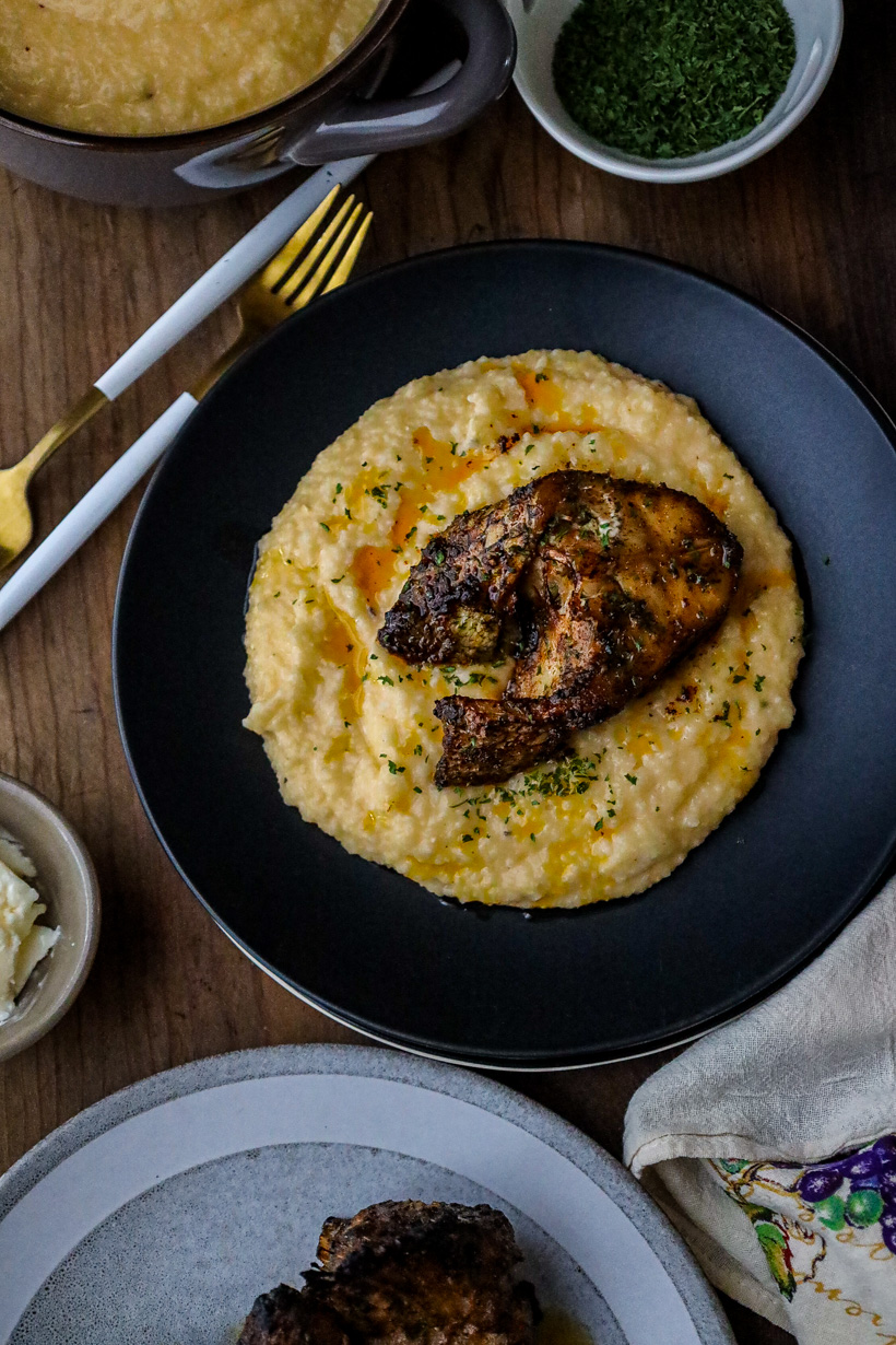 grits and fish recipe on black plate