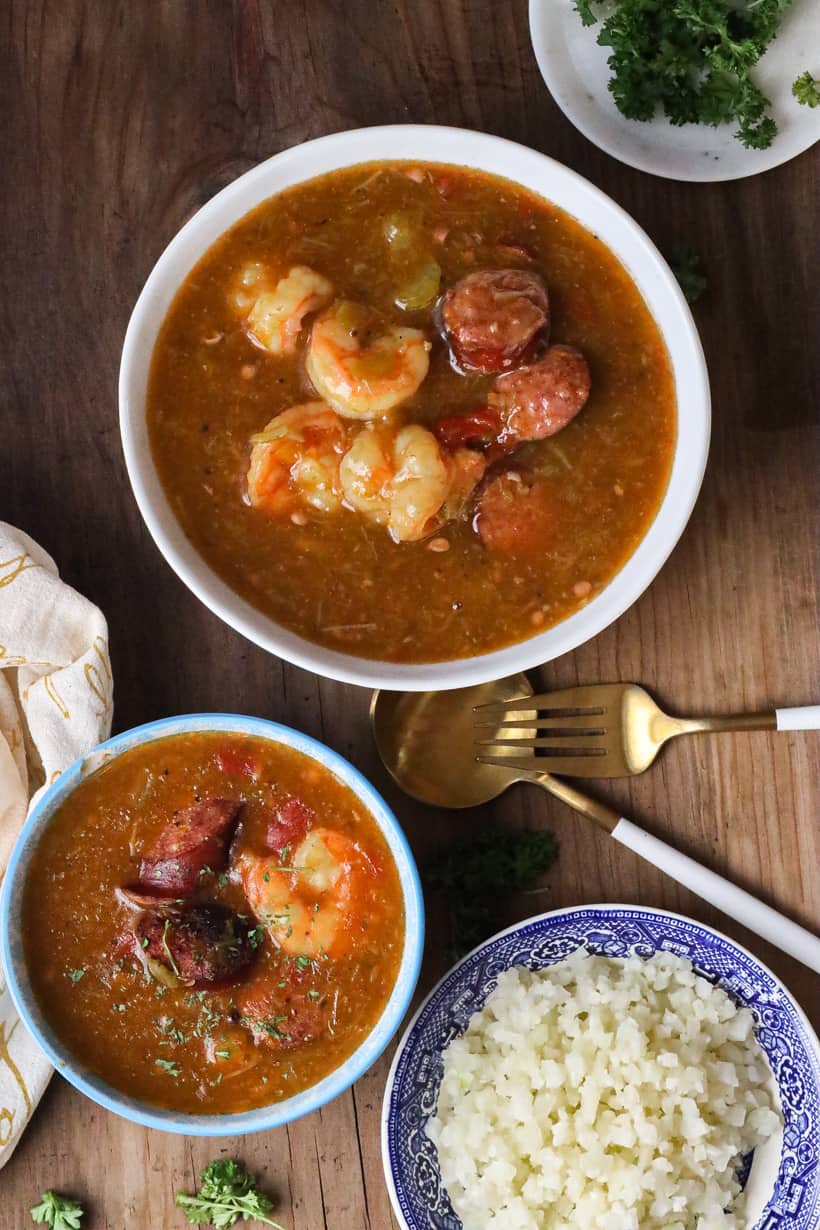 gumbo in white plate with fork and spoon