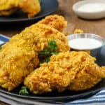 party wings on black plate with herbs