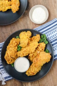 wings on black plate with dipping sauce