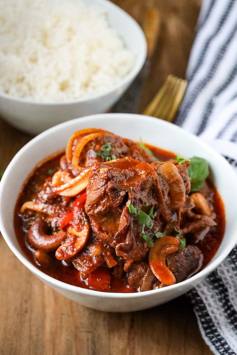 poulet au noix in white plate on wooden board