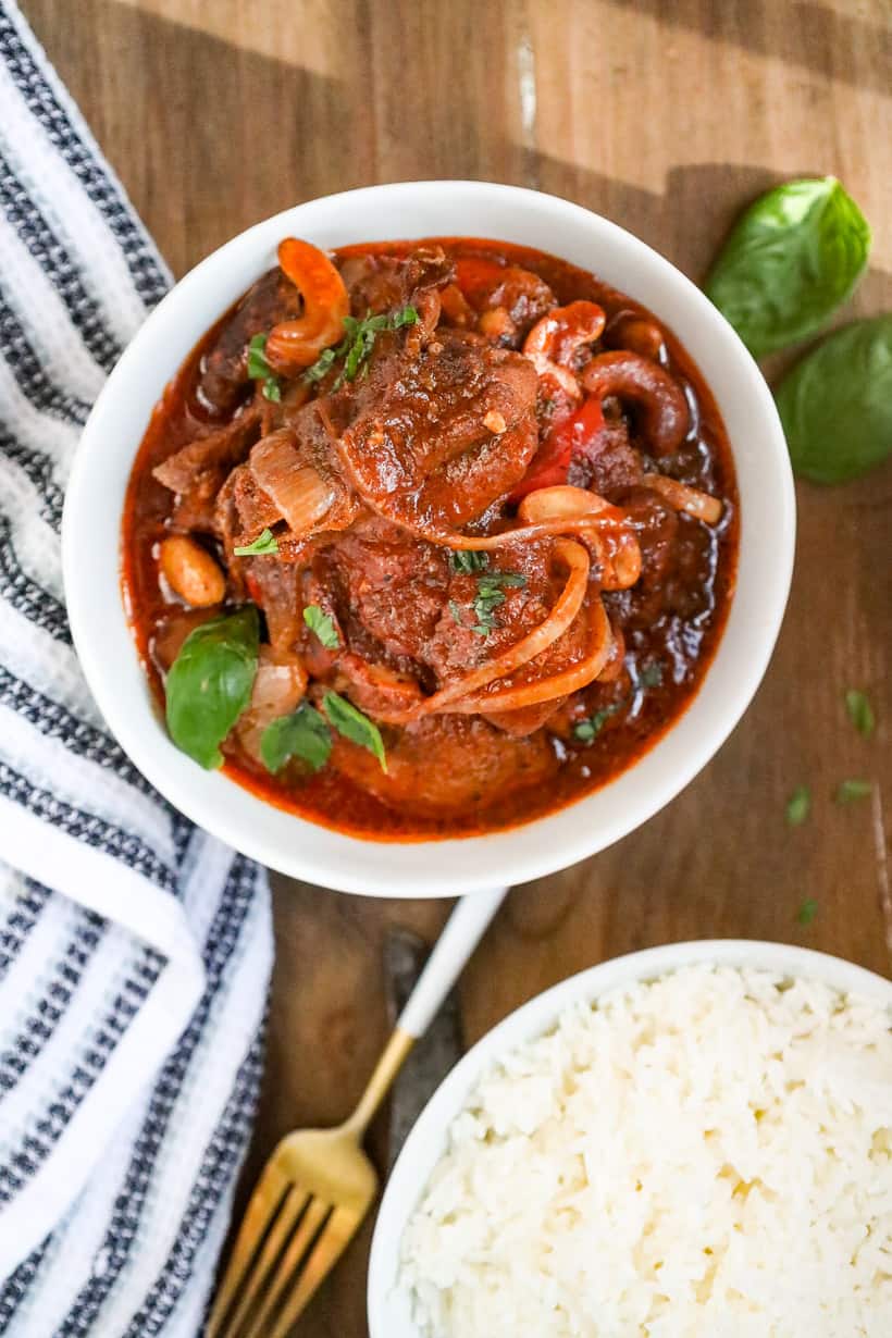 Haitian chicken stew with cashews in white plate