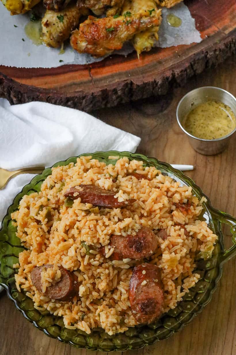 dirty rice with sausage in green plate